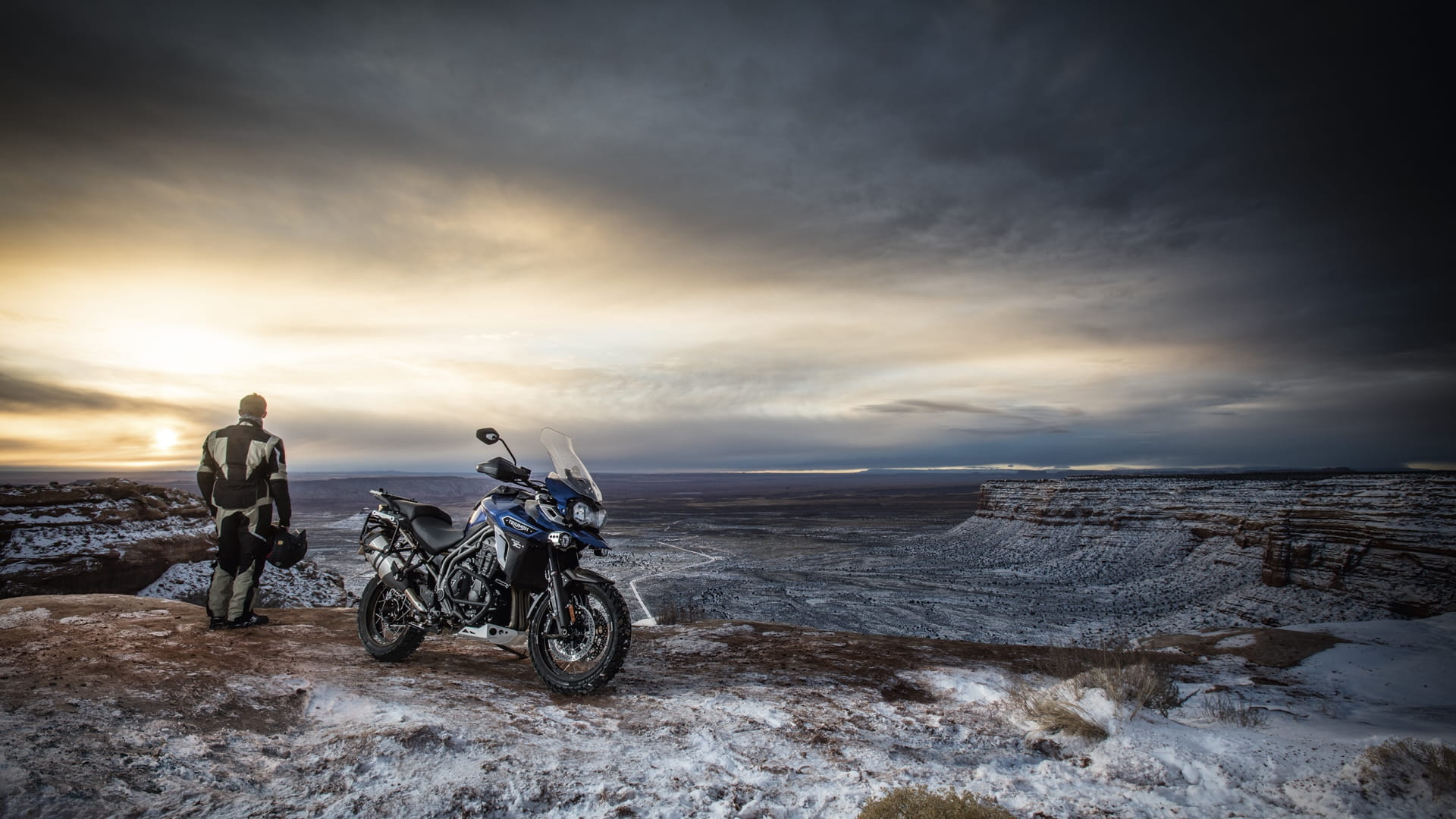 Triumph Tiger Explorer shot with rider looking into a dip in the background 