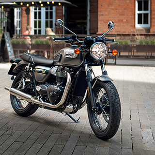 An image of a Model Year 2022 Bonneville T100 on a city street.